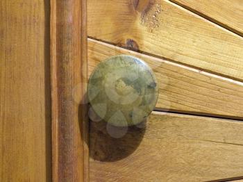 Fragment of a wooden door and door handle.