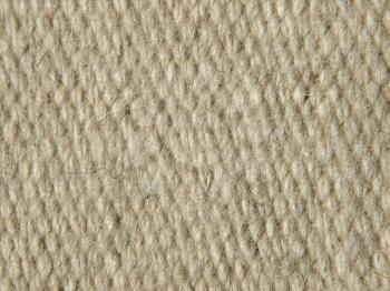 Rough beige camel wool fabric texture taken closeup as background.