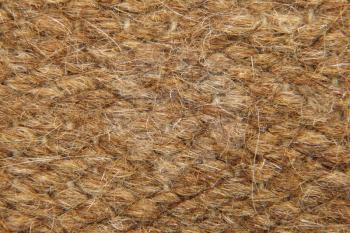 Brown rough camel wool fabric texture taken closeup suitable as background.