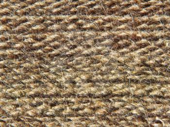 Rough knit camel wool fabric texture taken closeup as background.