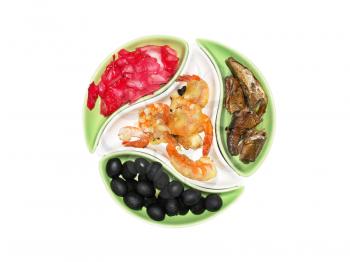 Various snack in multicolored plates isolated on white background.
