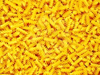 Dry pasta spirals suitable as background.
