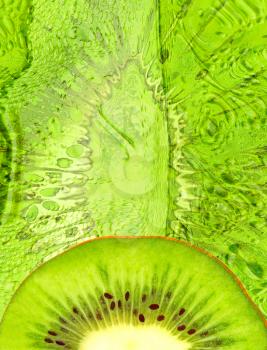 Half of green kiwi slice on green abstract background.Digitally generated image.