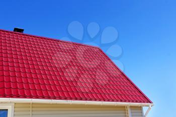 New red roof tiles against of blue sky.