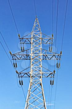 Electricity pylon taken closeup against of blue sky.