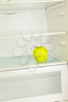 Lifestyle concept.Yellow apple in domestic refrigerator.