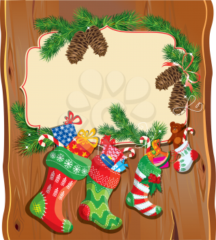 X-mas and New Year card with family Christmas stockings on wood background. Frame with empty space for text.