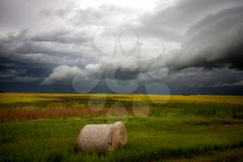 Storm Clouds Saskatchewan with hay bale and field