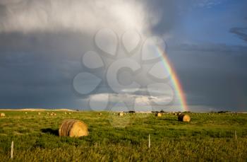 Storm Clouds Saskatchewan with rainbow and hay bales
