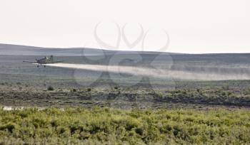 Crop Duster spraying in Saskatchewan Canada field