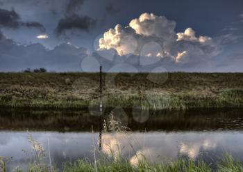 Storm Clouds Saskatchewan reflection in roadside water