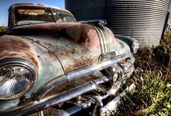Old Vintage car amongst granaries Saskatchewan Canada