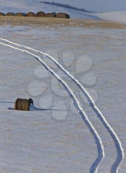 Hay Bale and tractor tracks Saskatchewan Canada winter cold