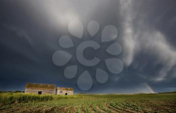 Abandoned Farm with storm clouds in the Canadian Prairie