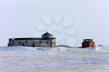 Caboose and Farm Buildings in Winter Saskatchewan