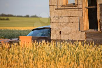 abandoned farm house and car in scenic Saskatchewan