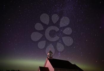 Northern Lights and star tracks over Saint Columba church