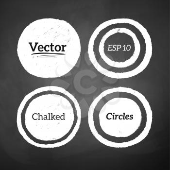 Hand drawn chalked circles and rings on blackboard background. Vector set