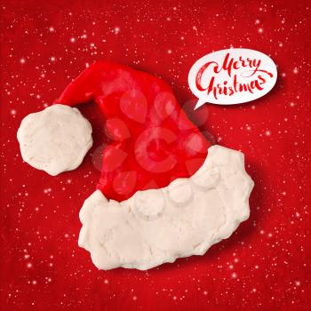 Vector hand made plasticine figure of Santa hat with shadow isolated on red festive grunge bacground with snowfall and light sparkles.