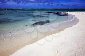 beach and  footstep in ile du cerfs mauritius