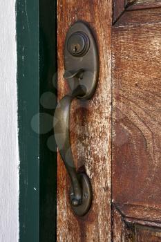 a brass brown knocker and wood  door colonia del sacramento uruguay