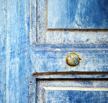 stripped paint in the blue wood door and rusty nail