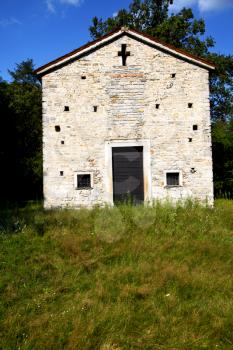  italy  lombardy     in  the arsago seprio   old   church  closed brick tower      wall grass