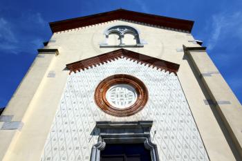 crugnola italy   church  varese  the old door entrance and abstracr mosaic sunny daY rose window
