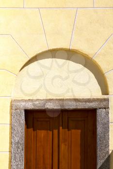 cairate abstract   rusty brass brown knocker in a  door curch  closed wood italy  lombardy 