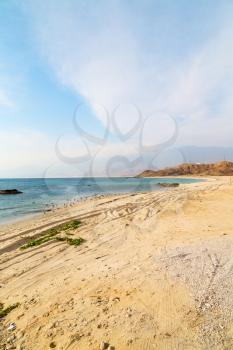 near sandy beach sky and mountain  in oman arabic sea  the hill 