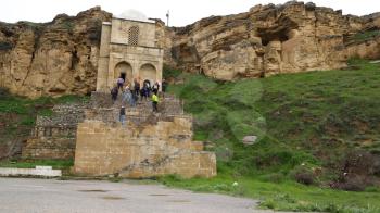 AZERBAIJAN, DIRI BABA-CIRCA MAY 2019--unidentified people near the antique mausoleum
