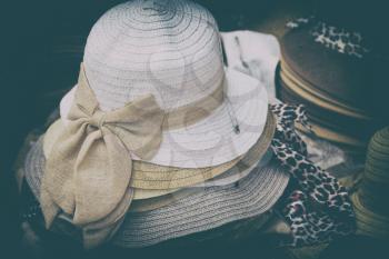 in a old market lots of colorated hats  like background clothes