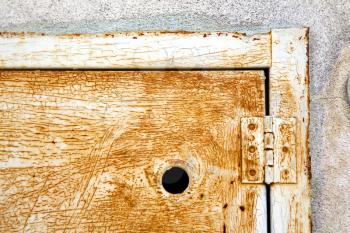 abstract  steel  padock in a   closed rusty metal pattern door   varese italy sumirago