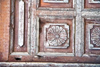 stripped paint in the blue  wood door and rusty    nail