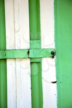 metal   green    morocco in    africa the old wood  facade home and rusty safe padlock 