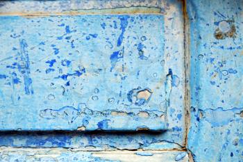 stripped paint in the blue wood door and rusty nail