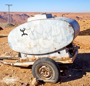 water tank in morocco africa land gray  metal weel and arid