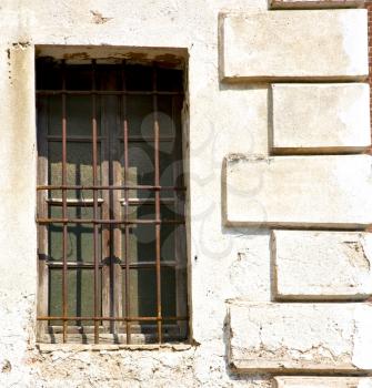 santo antonino window  varese palaces italy   abstract  sunny day    wood venetian blind in the concrete  brick
