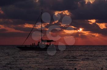 sailing boat sunset red and relax near the jamaica caribbean beach 