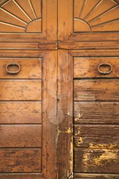  varese abstract  rusty brass brown knocker in a   closed wood door vedano olona italy
