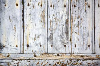  cross lombardy   arsago seprio abstract   rusty brass brown knocker in a  door curch  closed wood italy