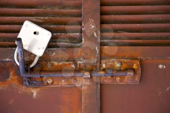 abstract cross   steel  padock in a   closed rusty door   varese italy mornago