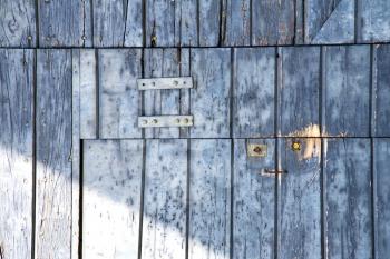abstract cross santo antonino  brass brown knocker in a   closed wood door   varese italy
