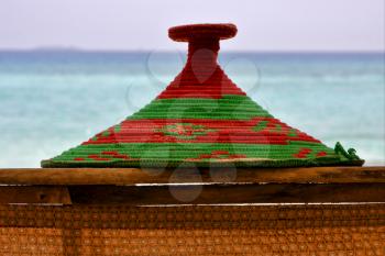 basket wicker rope sand and sea in zanzibar coastline