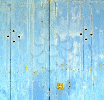 stripped paint in the blue wood door and rusty nail