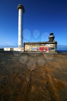 lighthouse and rock in the blue sky   arrecife teguise lanzarote spain
