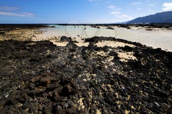 people spain  hill white  beach  spiral of black rocks in the   lanzarote 
