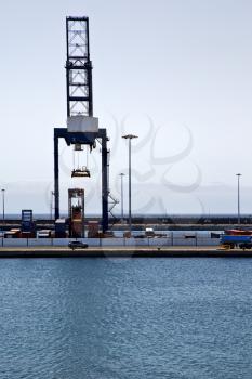 spain crane and harbor pier boat in the blue sky   arrecife teguise lanzarote 
