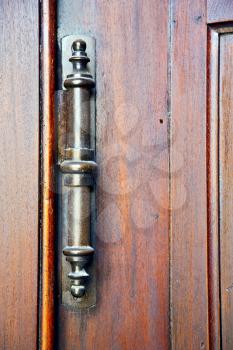 vedano olona abstract  rusty brass brown knocker in a  door  closed wood lombardy italy  varese