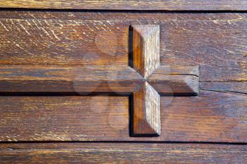 lombardy  arsago seprio   
 castellanza blur   abstract   rusty brass brown knocker in a  door curch  closed wood italy   cross

